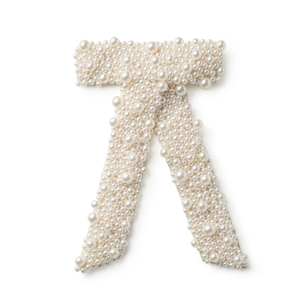 White pearl bow hair clip featuring faux pearls in a ribbon design