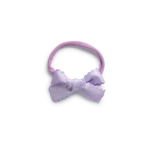 A lavender colored satin baby bow headband with scalloped detailing.