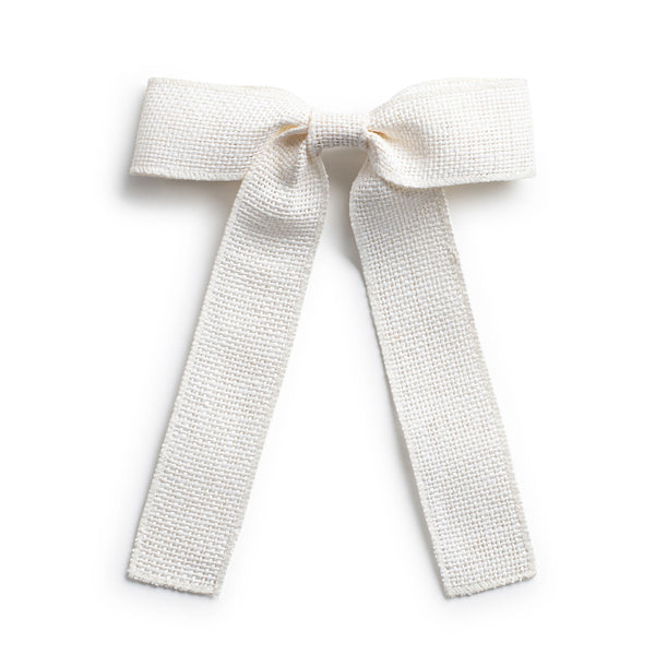 A white linen hair clip with a bow knot tail