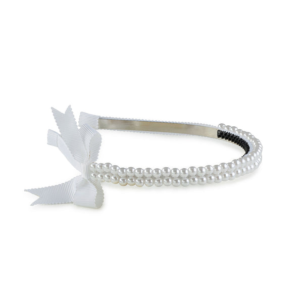 A white headband featuring a double-strand pearl design with a grosgrain bow on the side.