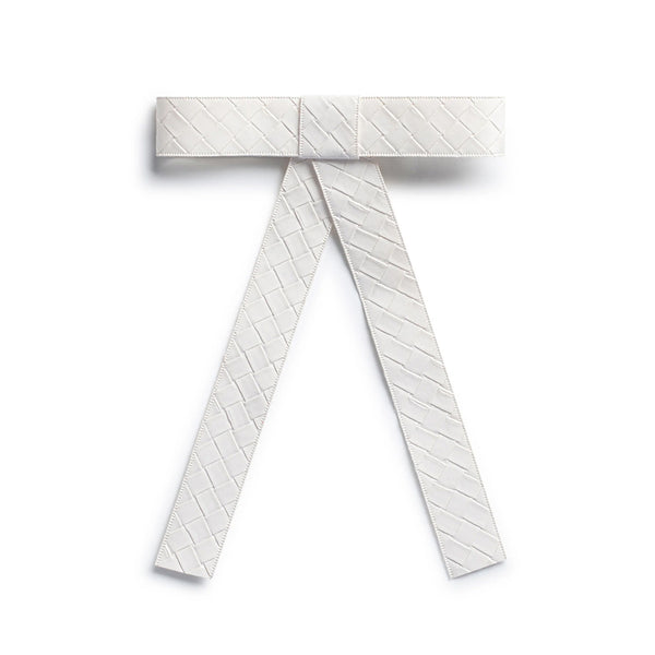 The image is of Halo Luxe Poppy Braided Woven Patent Clip in White it is a luxurious hair accessory designed to blend elegance with functionality.
Its Design & Material is Made from woven patent vegan leather, the clip features a hand-crafted bow knot tail with a self-textured finish.