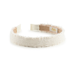 White textured headband with a visible brand label of haloluxe on a white background