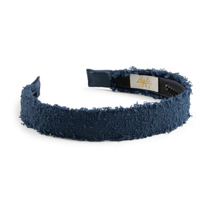 Navy blue textured headband with a visible brand label on a white background