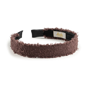 Brown fuzzy headband with a black elastic band on a white background