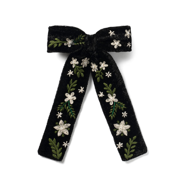 Black embroidered bow hair clip with floral patterns on it