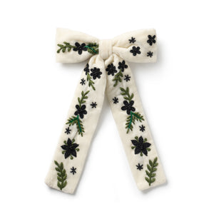 off white embroidered bow hair clip with floral patterns on it