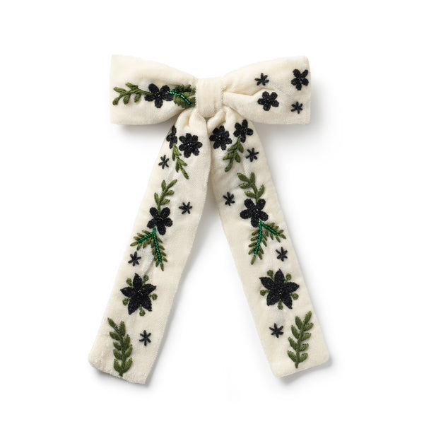 off white embroidered bow hair clip with floral patterns on it
