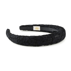 Black lace headband with a visible brand label on a white background