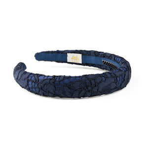 Navy blue lace headband on a white background