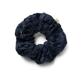 Navy blue lace scrunchie on a white background