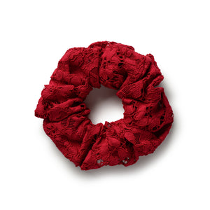 Red lace scrunchie on a white background