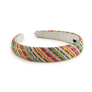 A multicolored striped linen headband with rubberized teeth on the inner face.