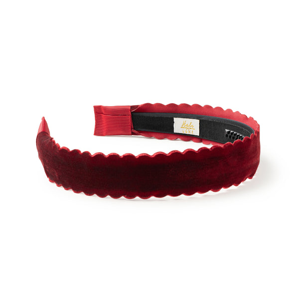 Red velvet headband with scalloped edge on a white background