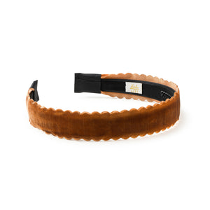 Brown velvet headband with black strap on a white background