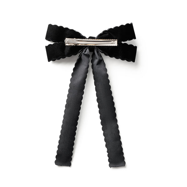 Black bow hair clip on a white background
