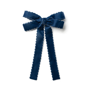 Blue bow hair clip on a white background