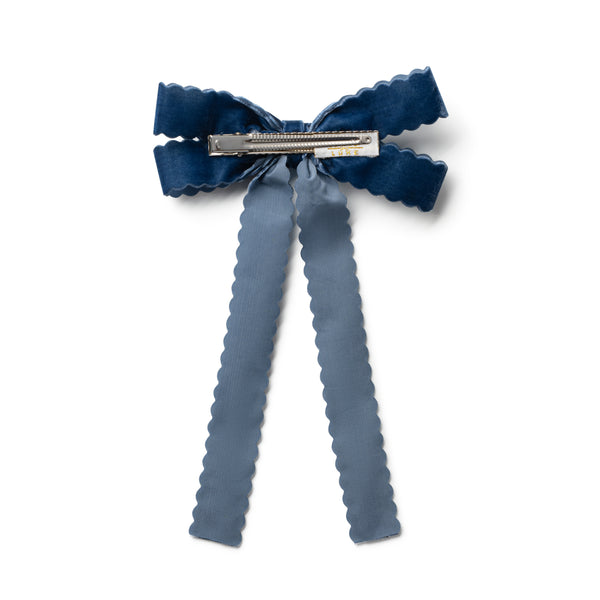 Blue bow hair clip on a white background
