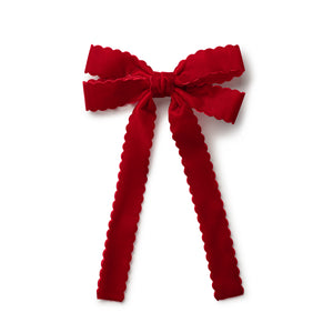 Red velvet bow clip on a white background