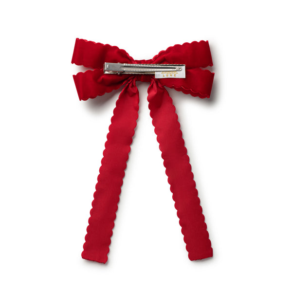 Red bow hair clip on a white background