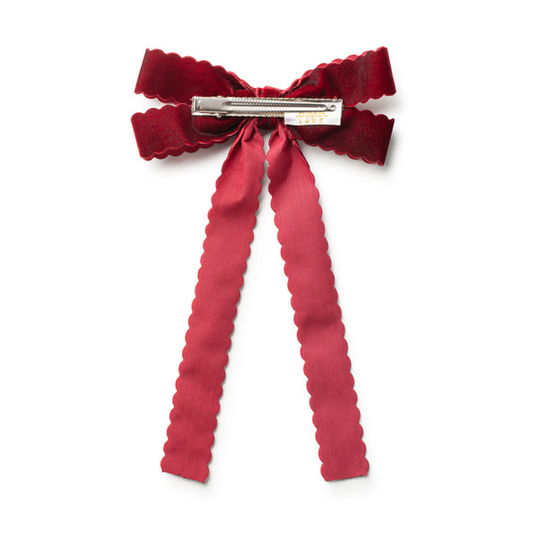 Red bow hair clip on a white background