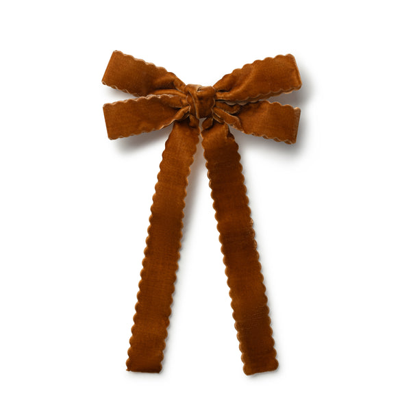 Brown velvet bow clip on a white background