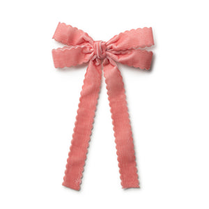 Pink velvet bow clip on a white background