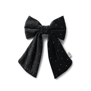 Black bow clip with white polka dots on a white background