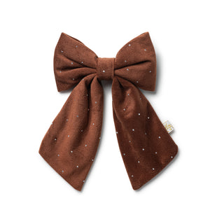 Brown bow with white polka dots on a white background