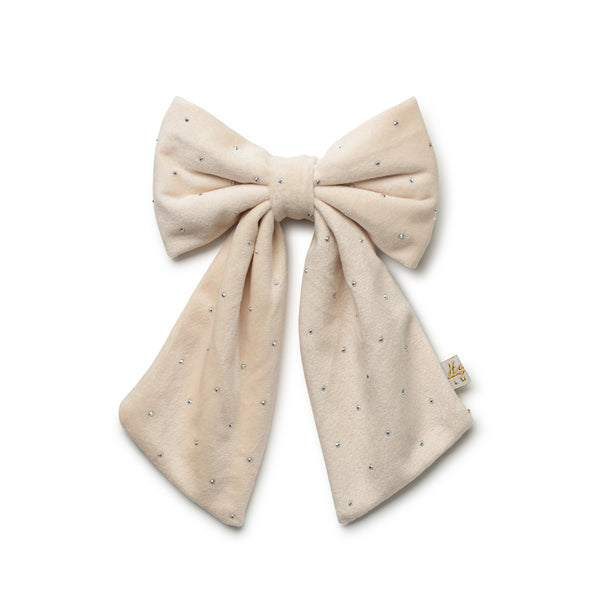 Beige bow with small embellishments on a white background