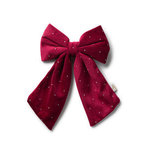 Red bow with white polka dots on a white background