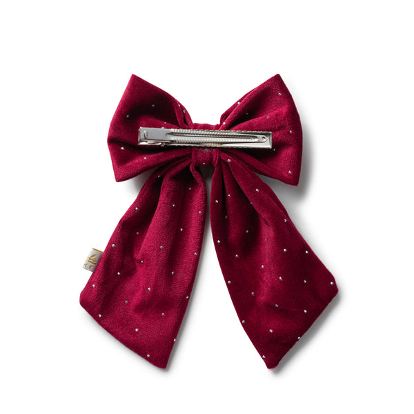 Red bow hair clip with a silver barrette on a white background
