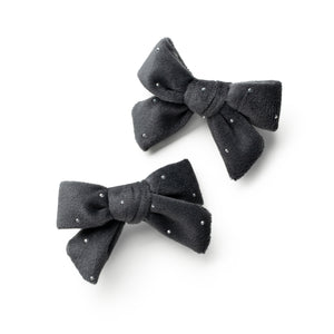 Two black hair bows with rhinestones on a white background