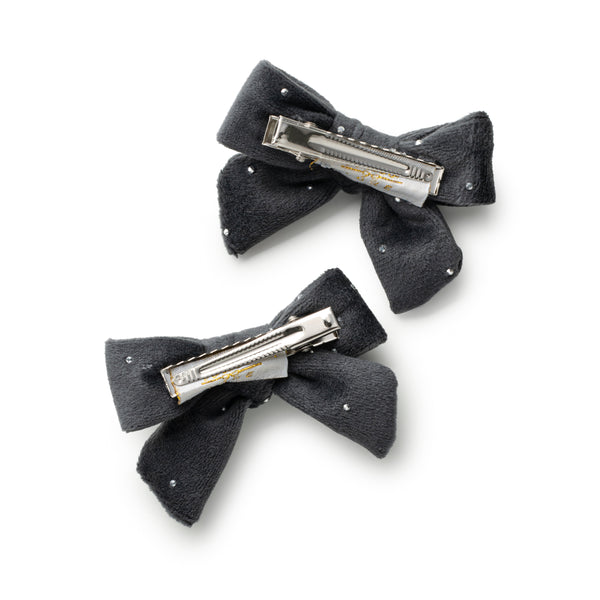 Two gray hair bows with metal clips on a white background