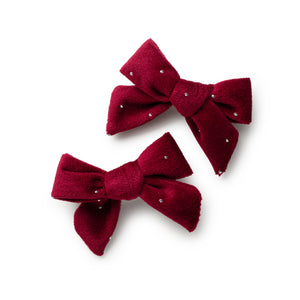 Red bow clip set with pearls on a white background