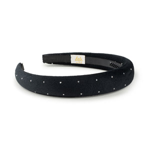 Black velvet headband with white polka dots on a white background