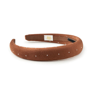 Brown headband with white polka dots on a white background