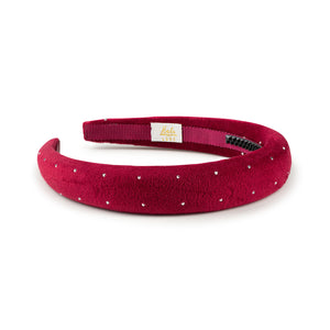 Red velvet headband with white polka dots on a white background