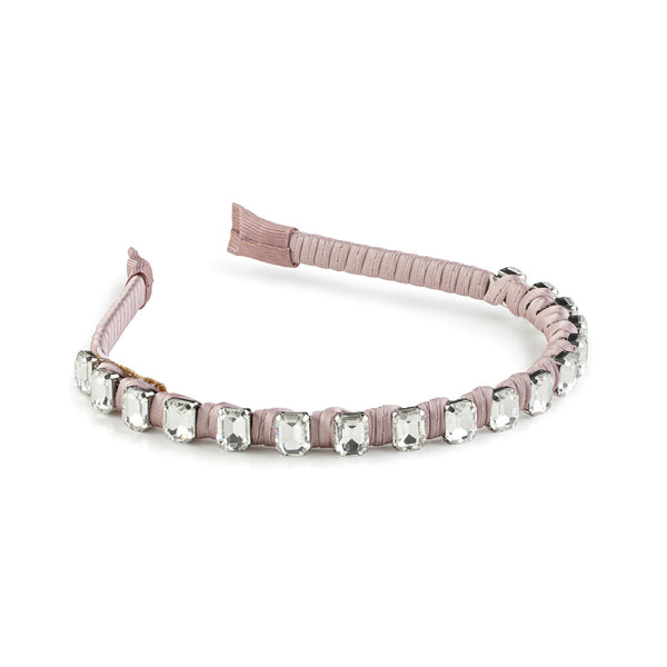 A satin wrapped headband with crystals in a mauve color