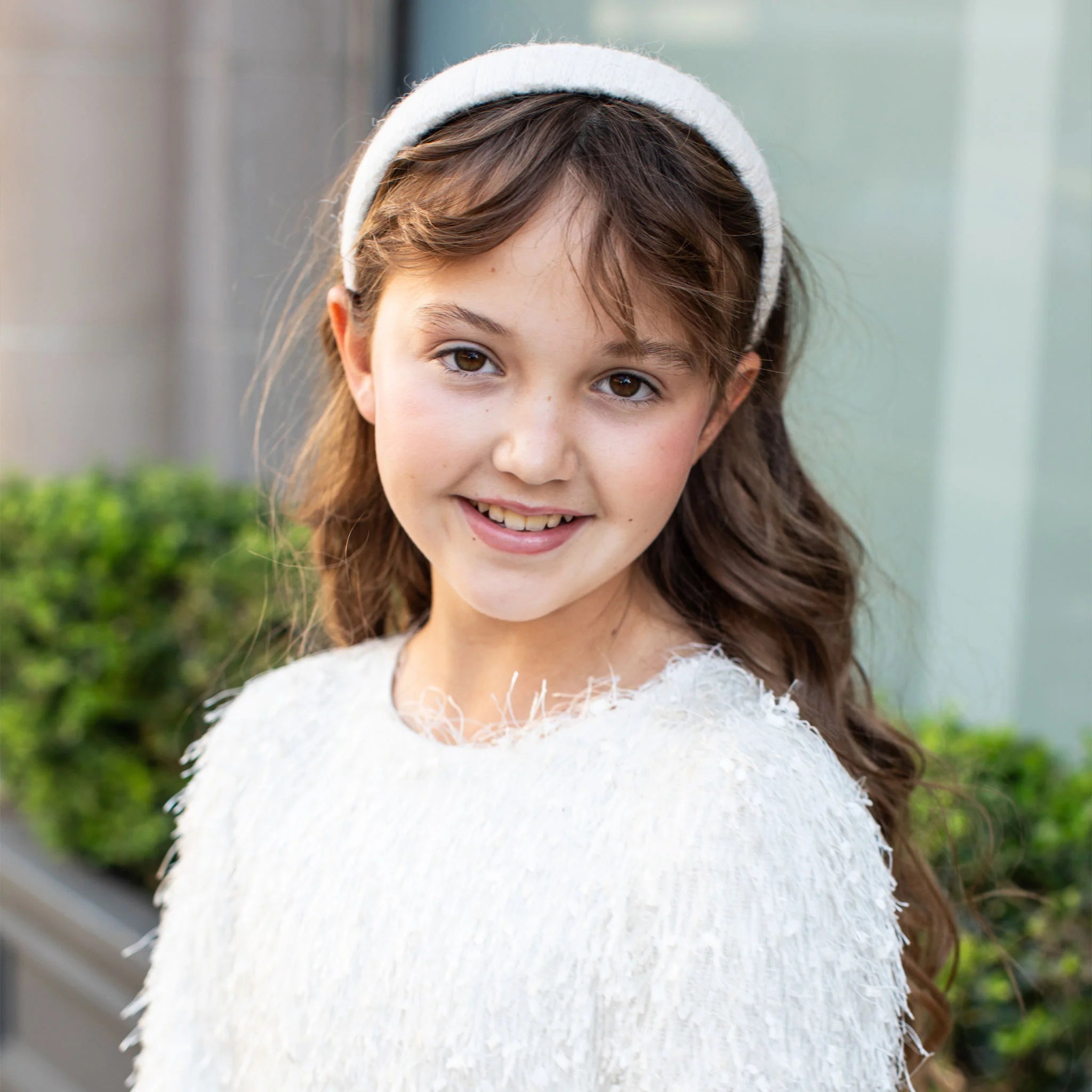 a girl wearing a white padded headband by haloluxe