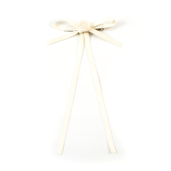 Cream-colored ribbon bow on a white background