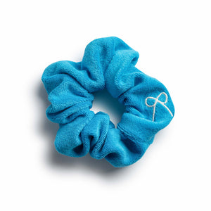 A teal colored Halo Luxe Terry scrunchie displayed on a neutral background.